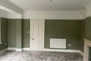 Somerset painters & decorators applying a fresh coat of paint to a living room wall, demonstrating painting & decorating services.