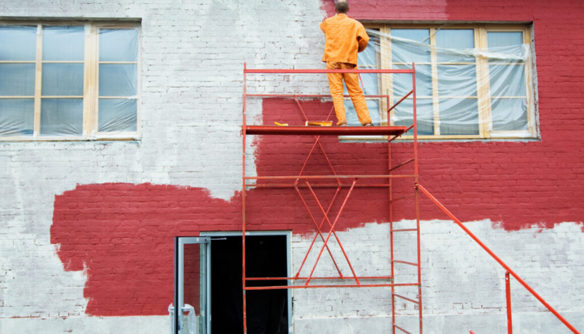 Weatherproof paint being applied to a brick wall.