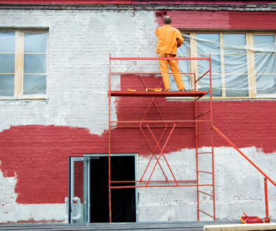 Weatherproof paint being applied to a brick wall.